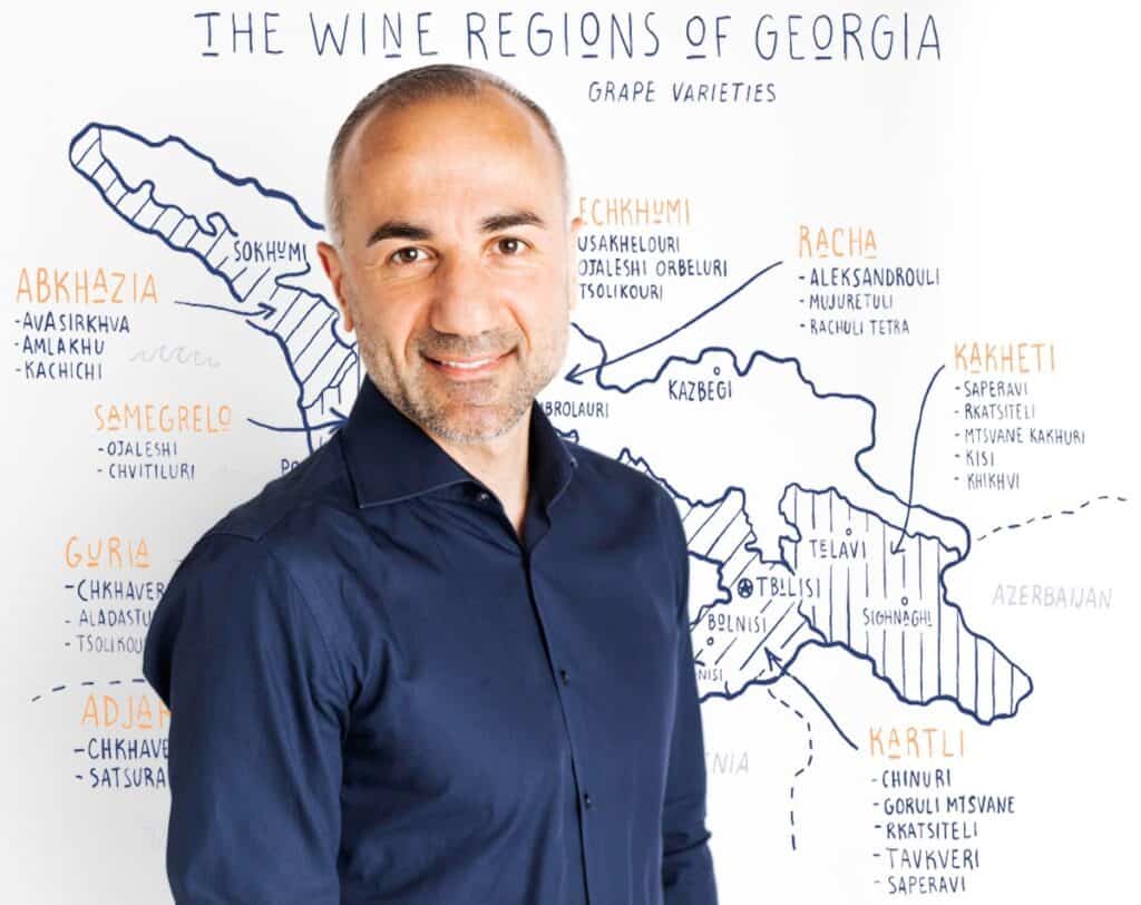 photo of Lasha Tsatava in front of a wine map of Georgia.