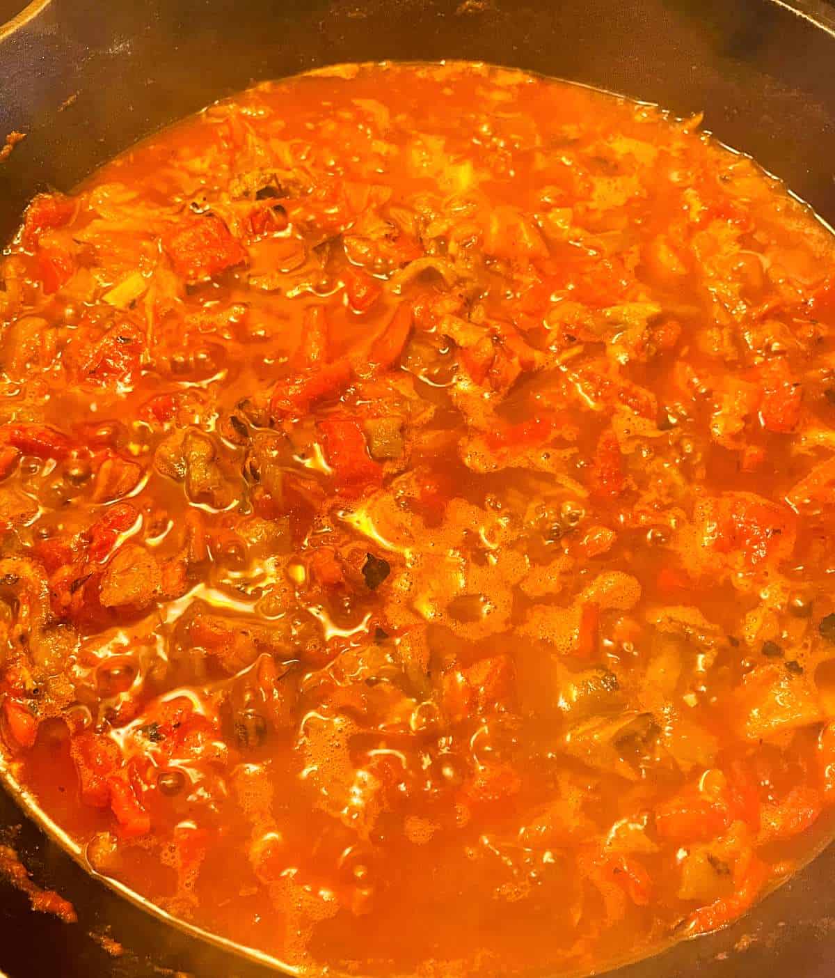 Hatch Chile enchilada sauce simmering in a black skillet.
