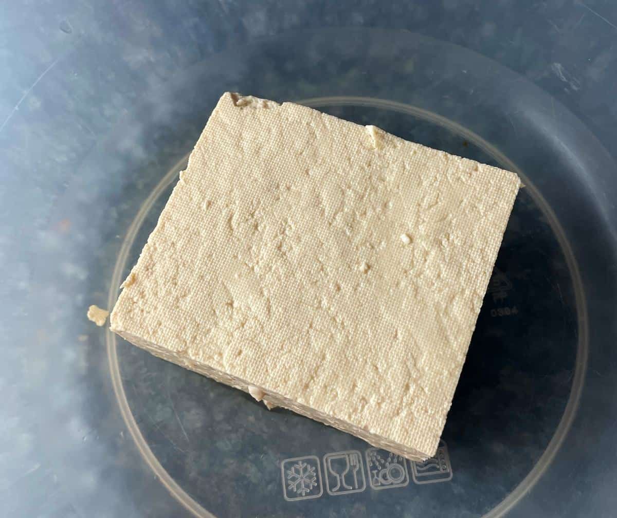 block of tofu in a bowl.