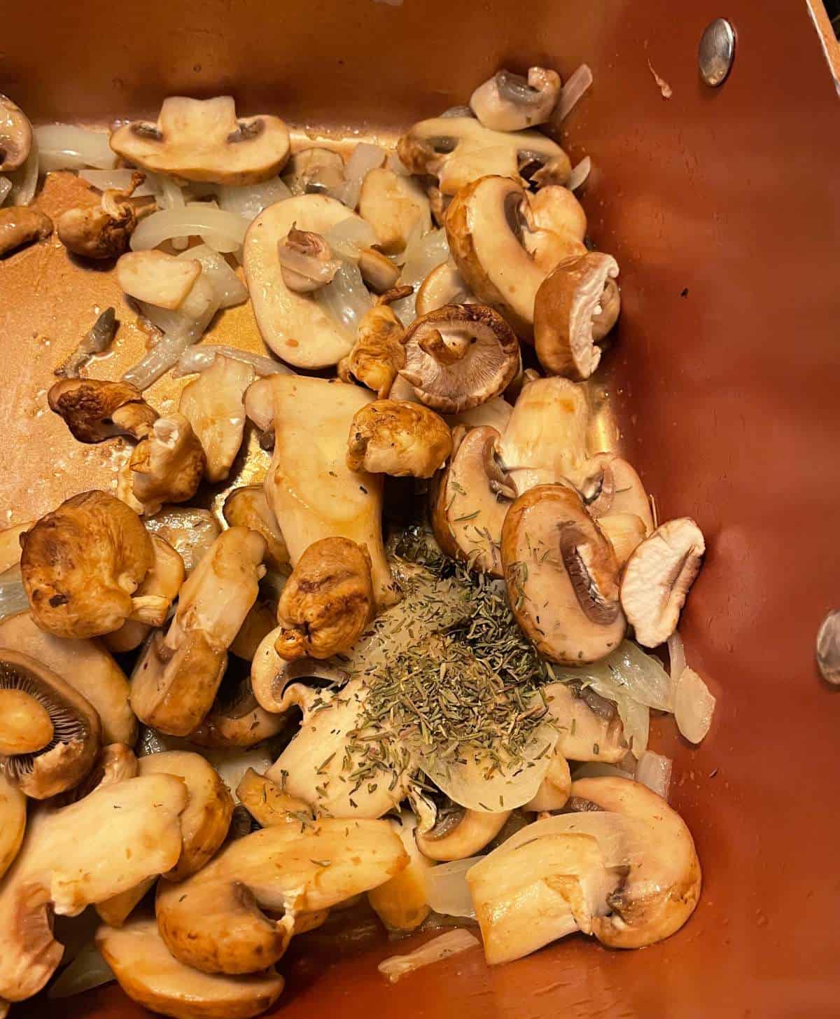 sautéing mushrooms in a pan to serve over salmon.