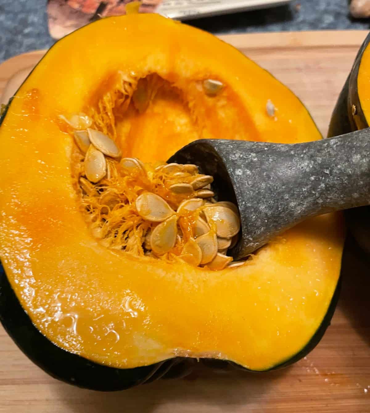Scooping out the seeds of an acorn squash