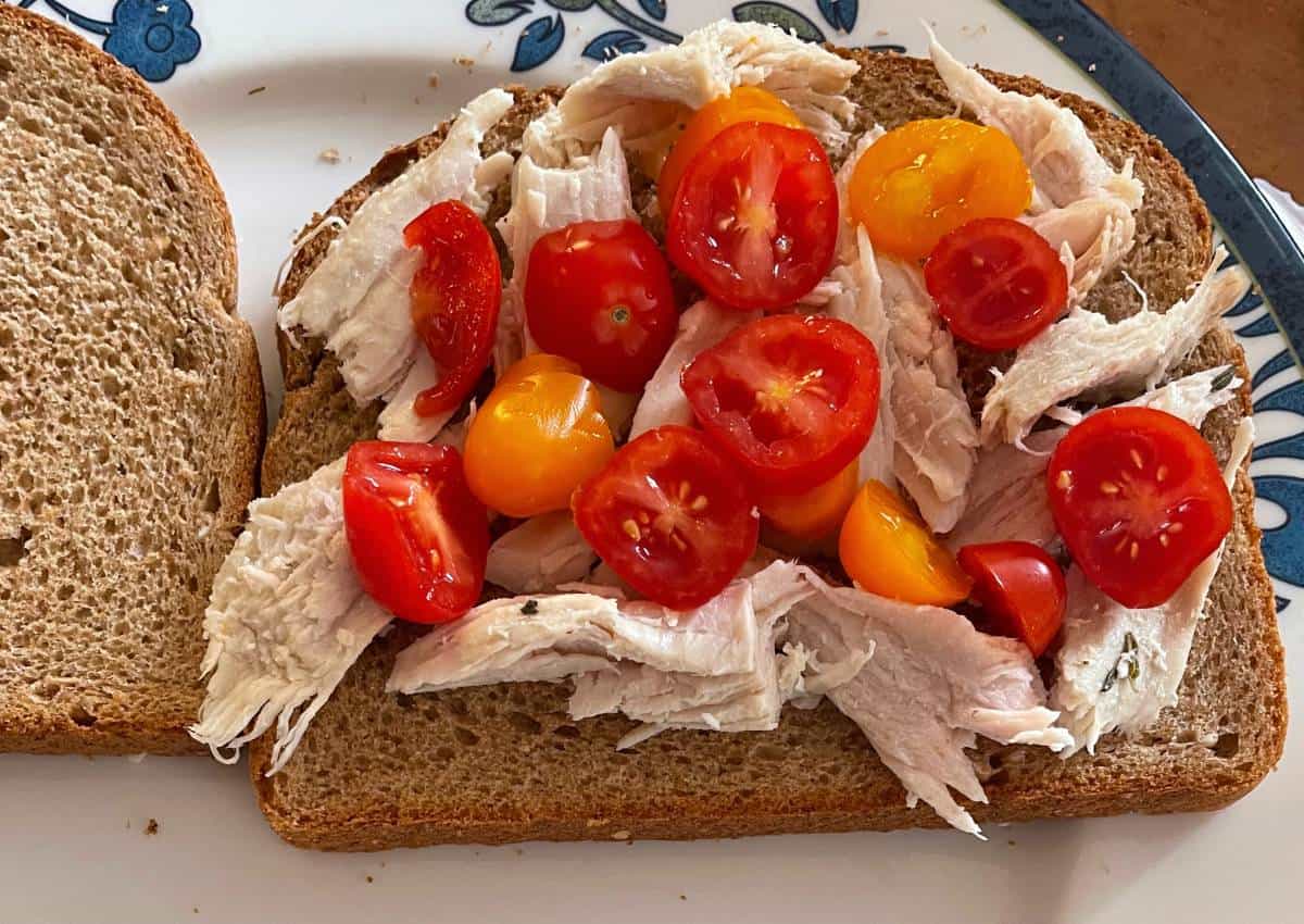 wheat bread with pieces of leftover turkey and chopped cherry tomatoes.