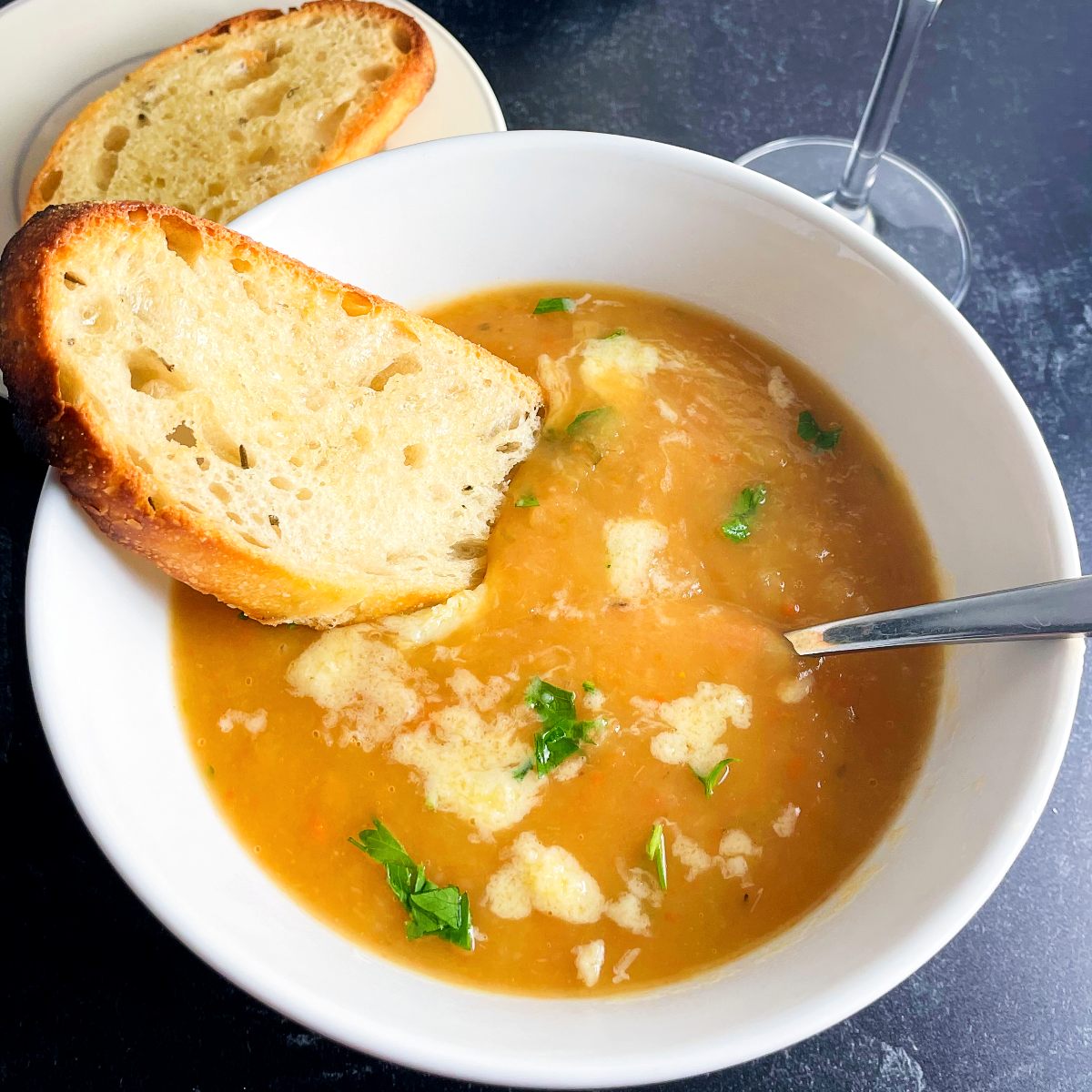 Irish vegetable soup served in a white bowl with toasted bread.