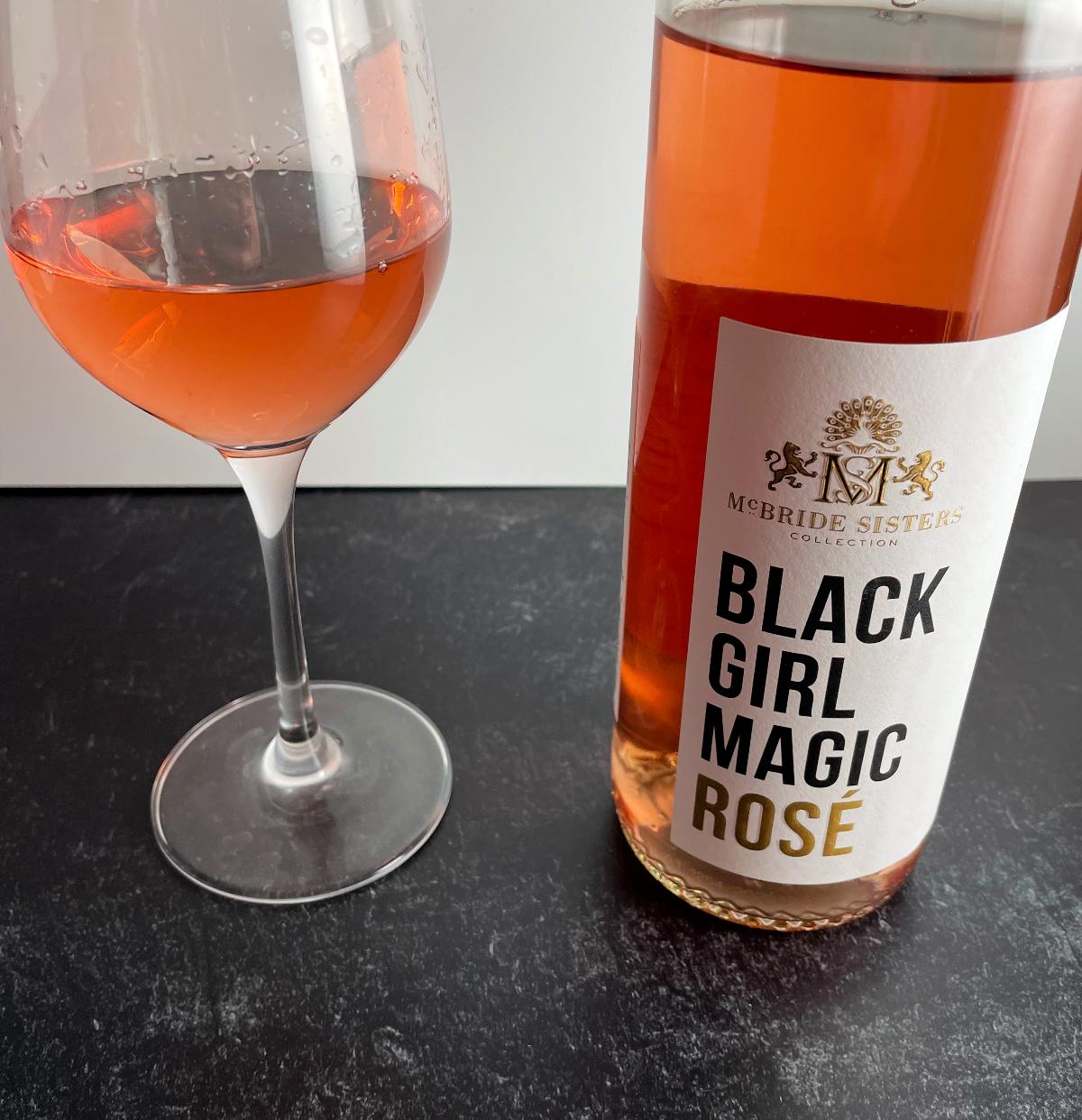 Bottle of Black Girl Magic rosé wine with a glass of the rosé. 