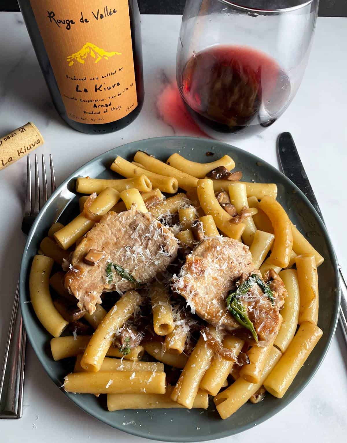 plate of pork tenderloin pasta served with a red wine from Northern Italy.