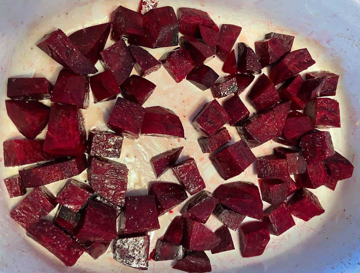chopped beets in a white baking dish.