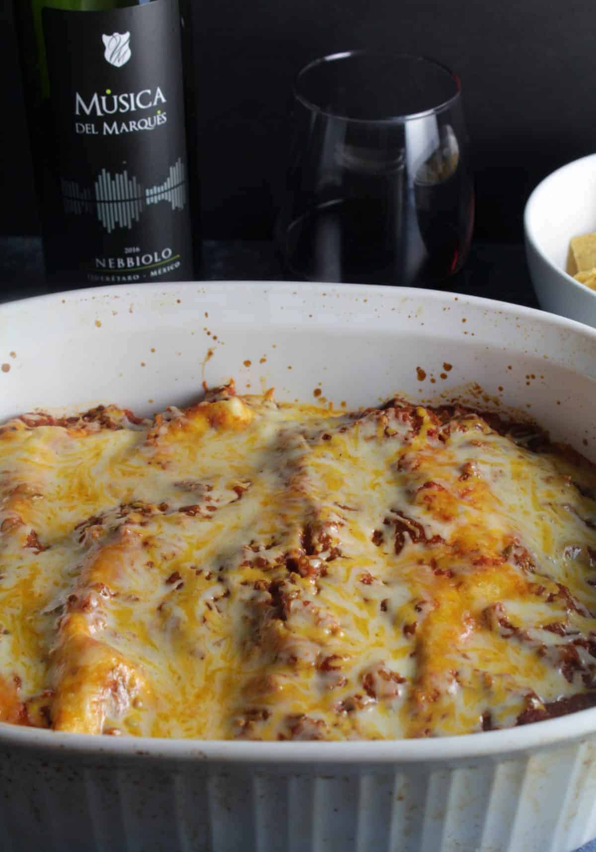 Ground turkey enchiladas in a baking dish, served with red wine from Mexico.