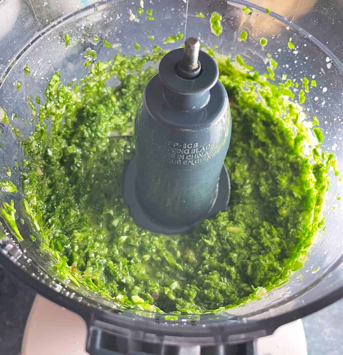 Radish green pesto purée in a food processor.