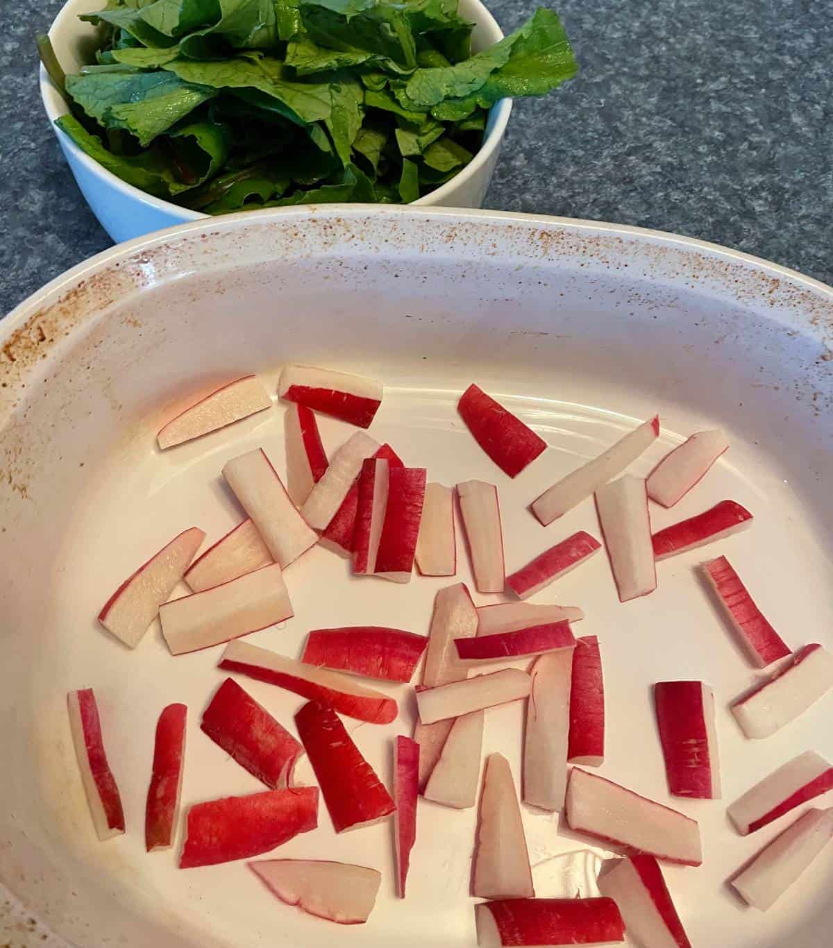 Chopped radish pieces in a white baking dish.