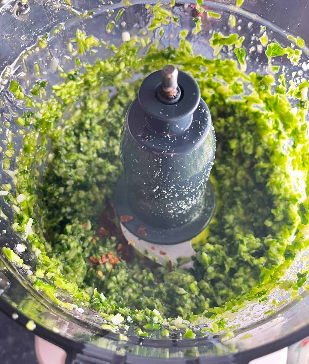 garlic scape pesto in a food processor, with red pepper flakes added. 