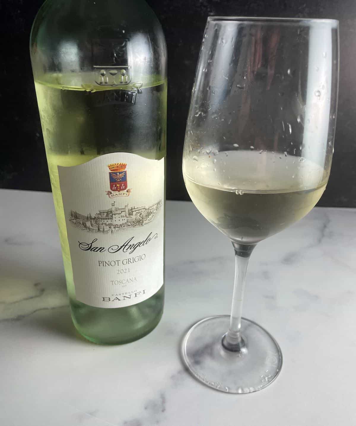 Bottle of San Angelo Pinot Grigio with a glass of the white wine alongside the bottle.