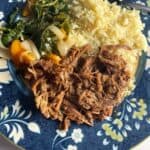 plate of pulled pork with a side of rice.