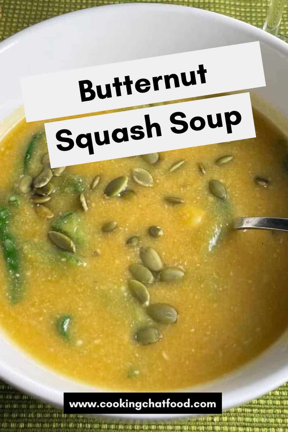 white bowl of butternut squash soup with spinach.