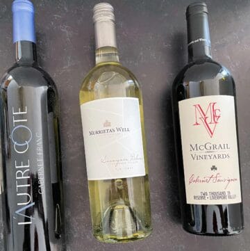 3 bottles of Livermore Valley wines lying on a dark surface.