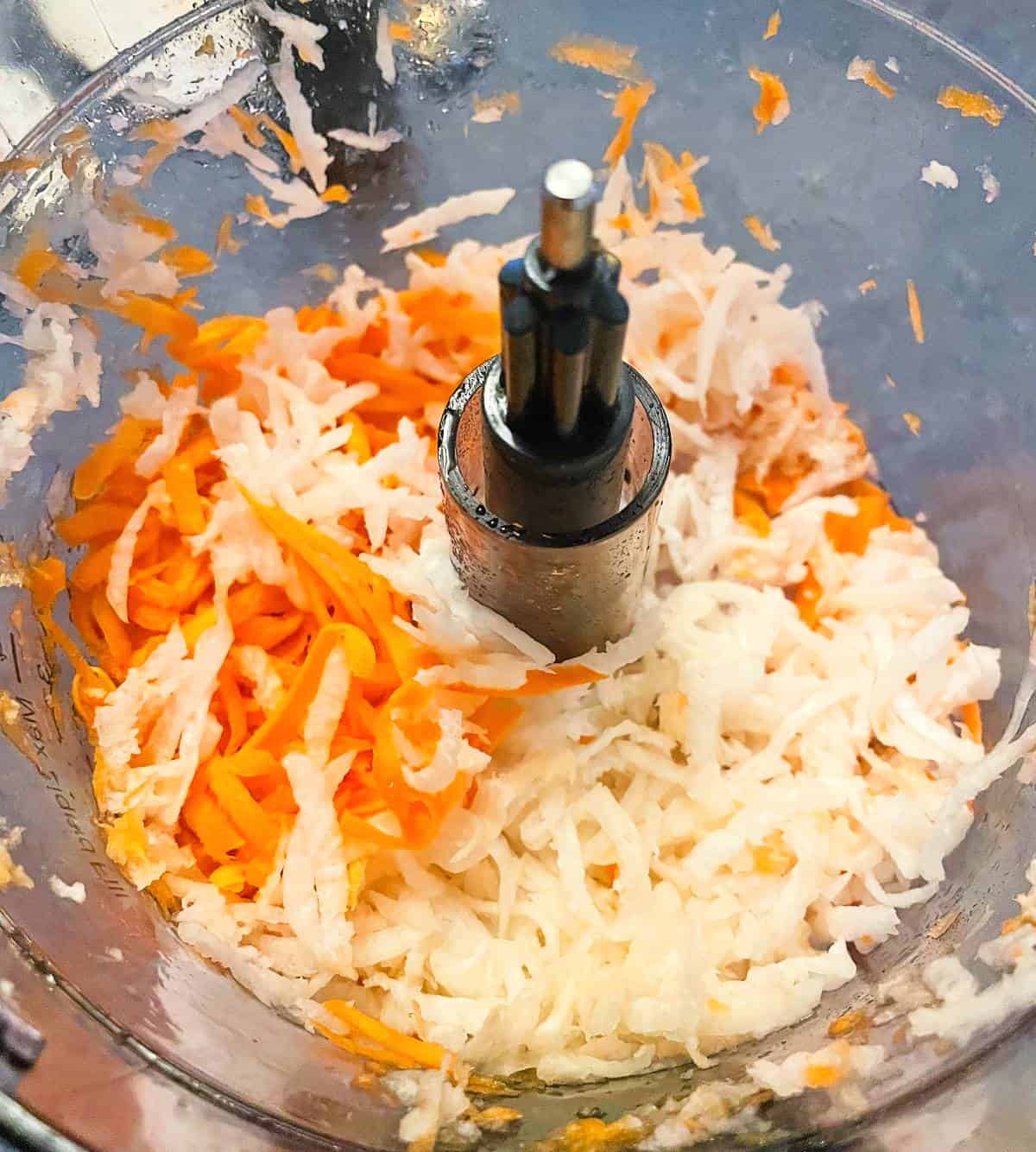 shredded carrots and daikon radish in a food processor.