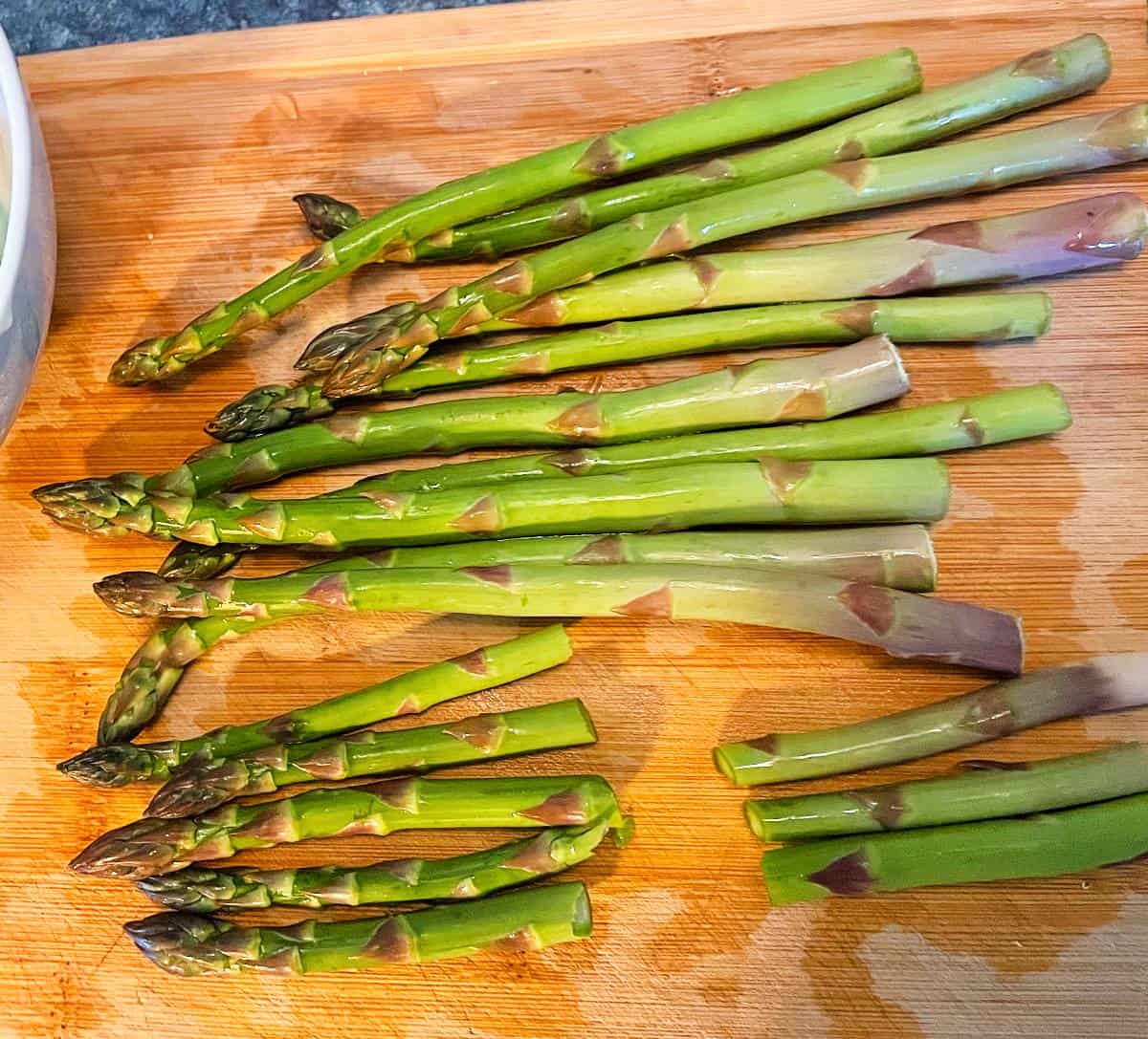 Preparing asparagus on a cutting board.