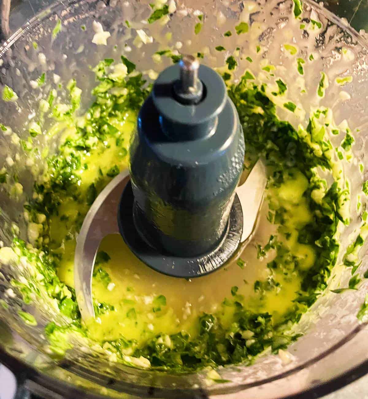 pureed basil and parsley in a food processor.