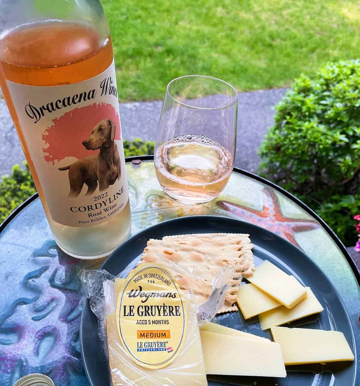 plate of gruyere cheese served with rosé wine.