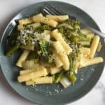 broccolini pasta with ziti on a gray plate.