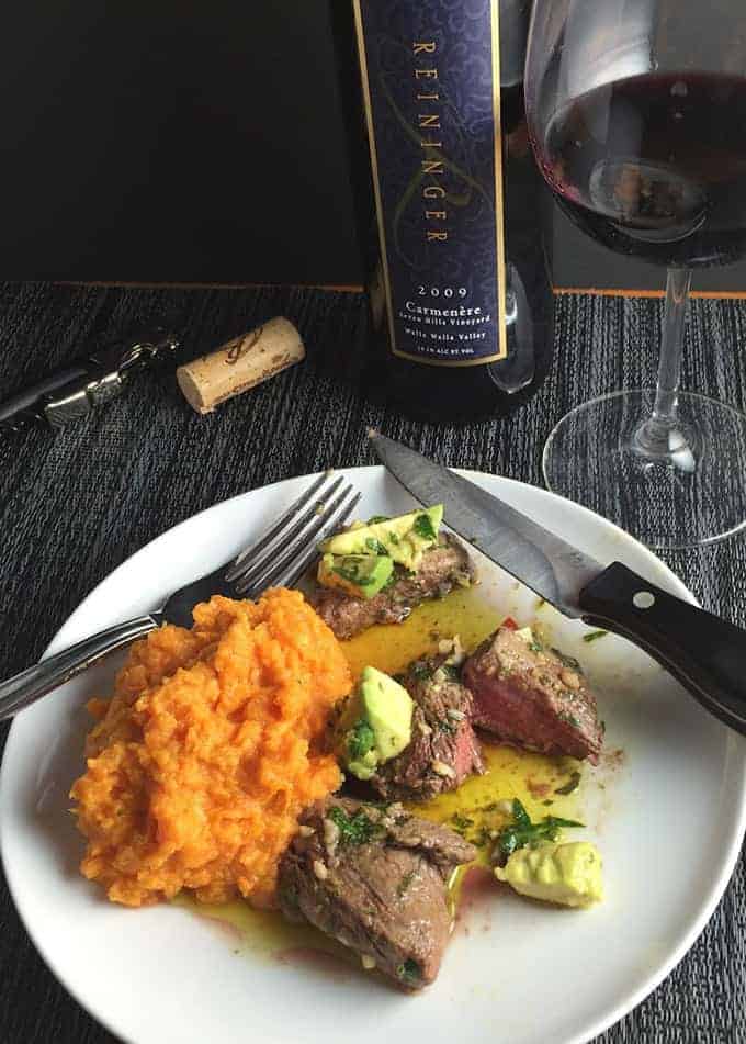 beef tenderloin plated with an avocado chimichurri sauce and served with a Carmenere wine.