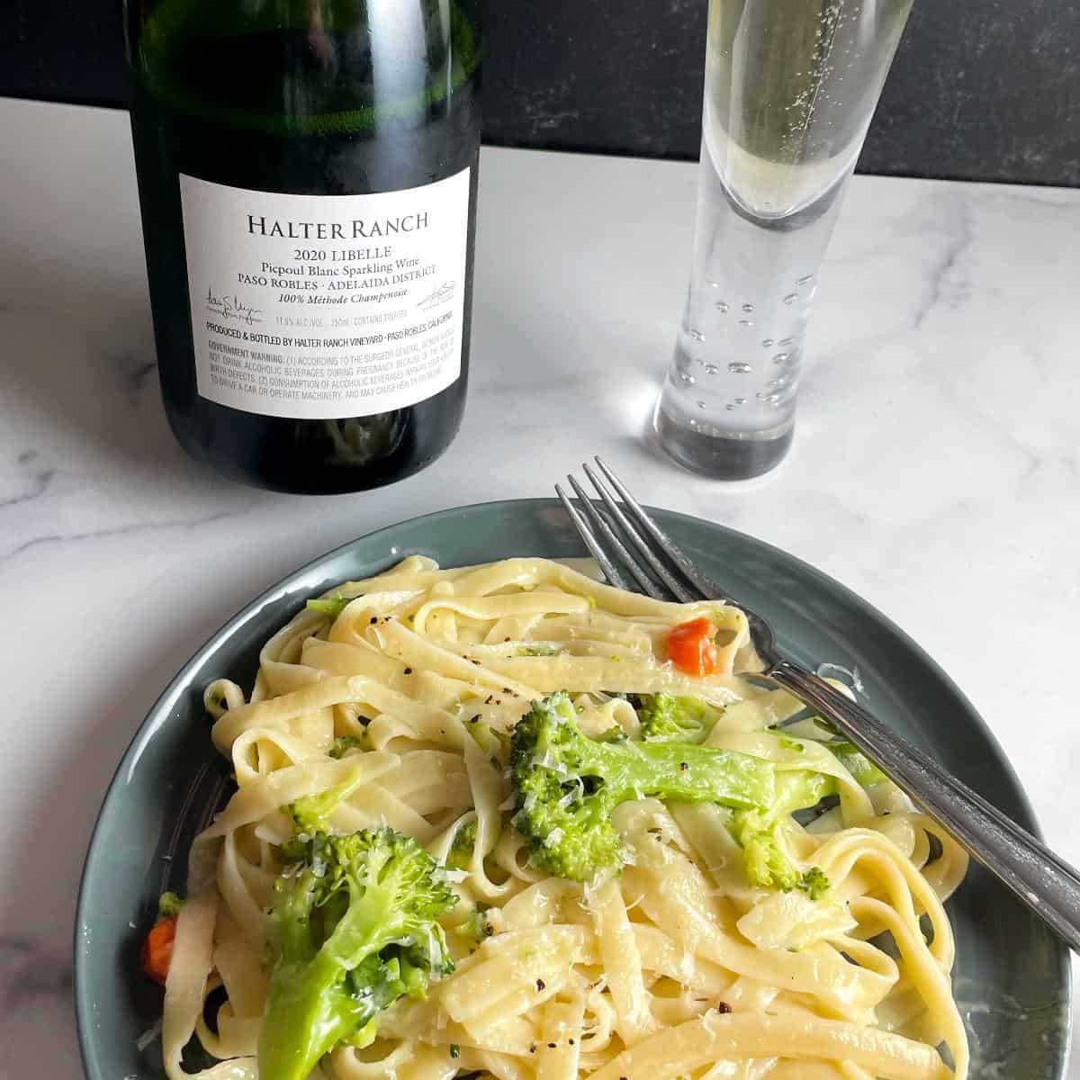 plate of fettuccine with a bottle and glass of Halter Ranch Libelle, a sparkling wine.