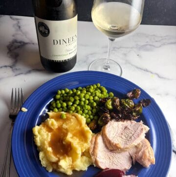 turkey dinner with a bottle of Condriesque wine in the background.