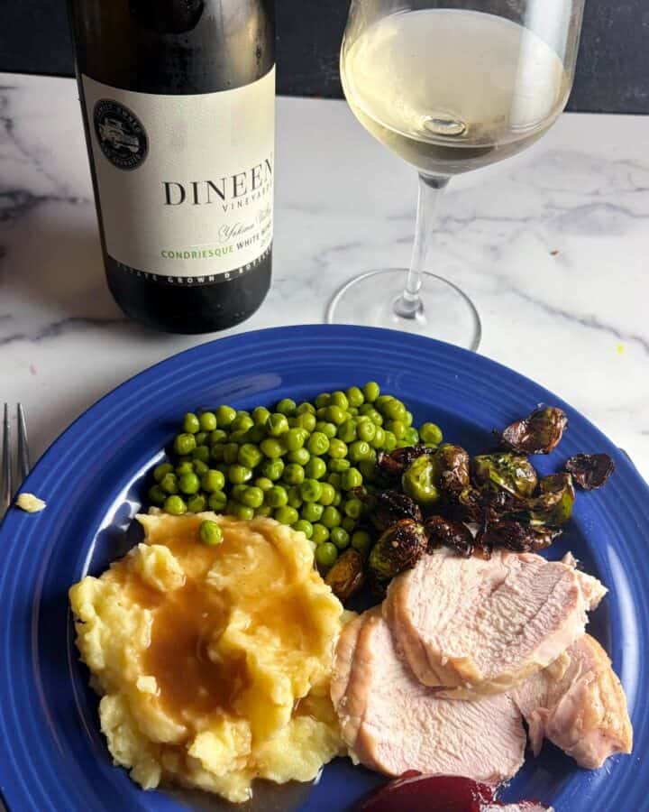 turkey dinner with a bottle of Condriesque wine in the background.