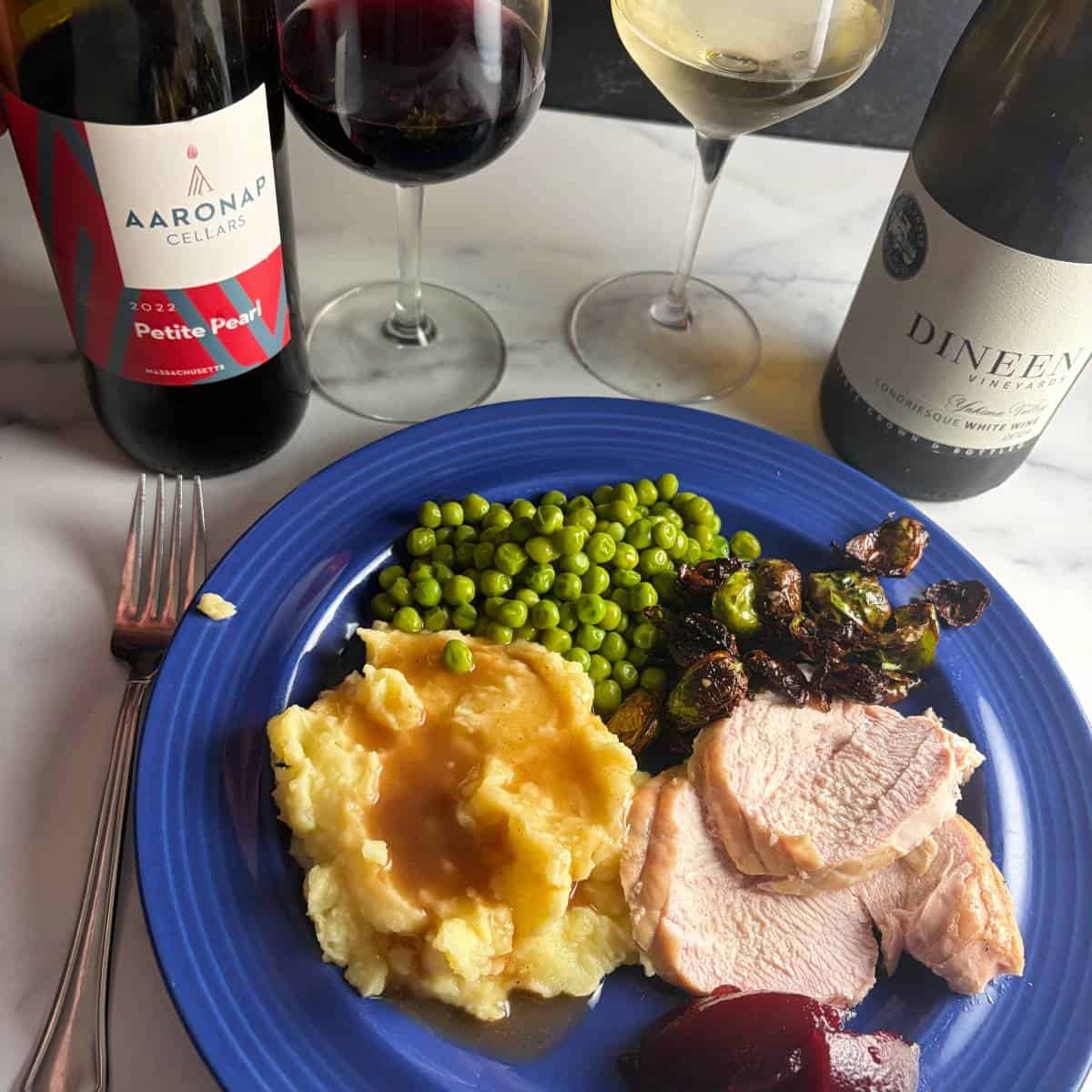 Turkey dinner served with a white wine and a red wine.