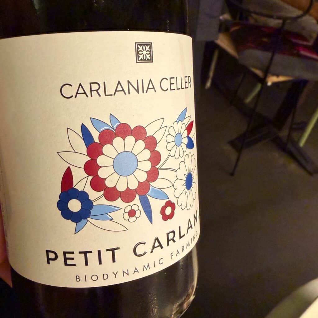 a bottle of Petit Carlania red wine.