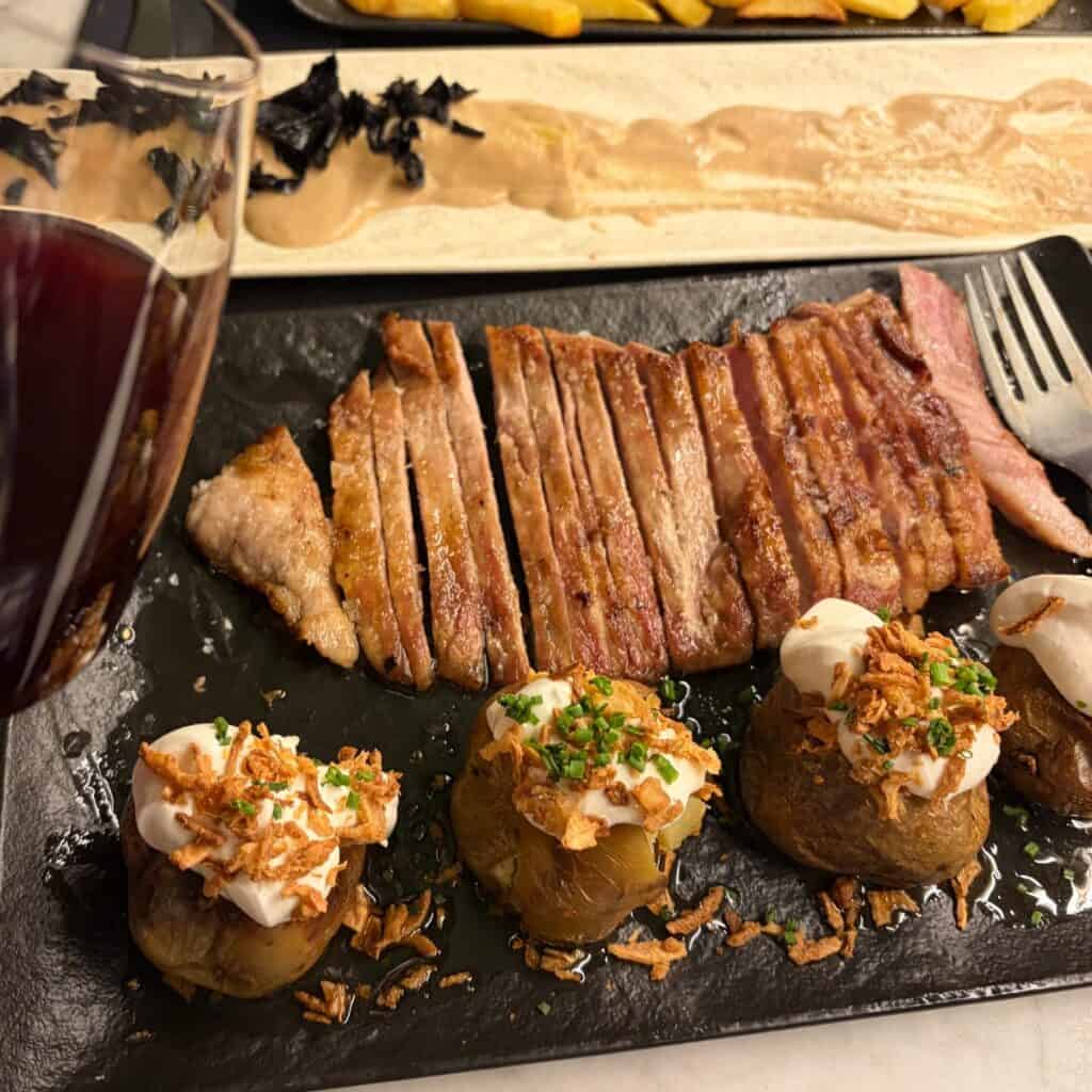 A Catalan pork dish served with potatoes and red wine.