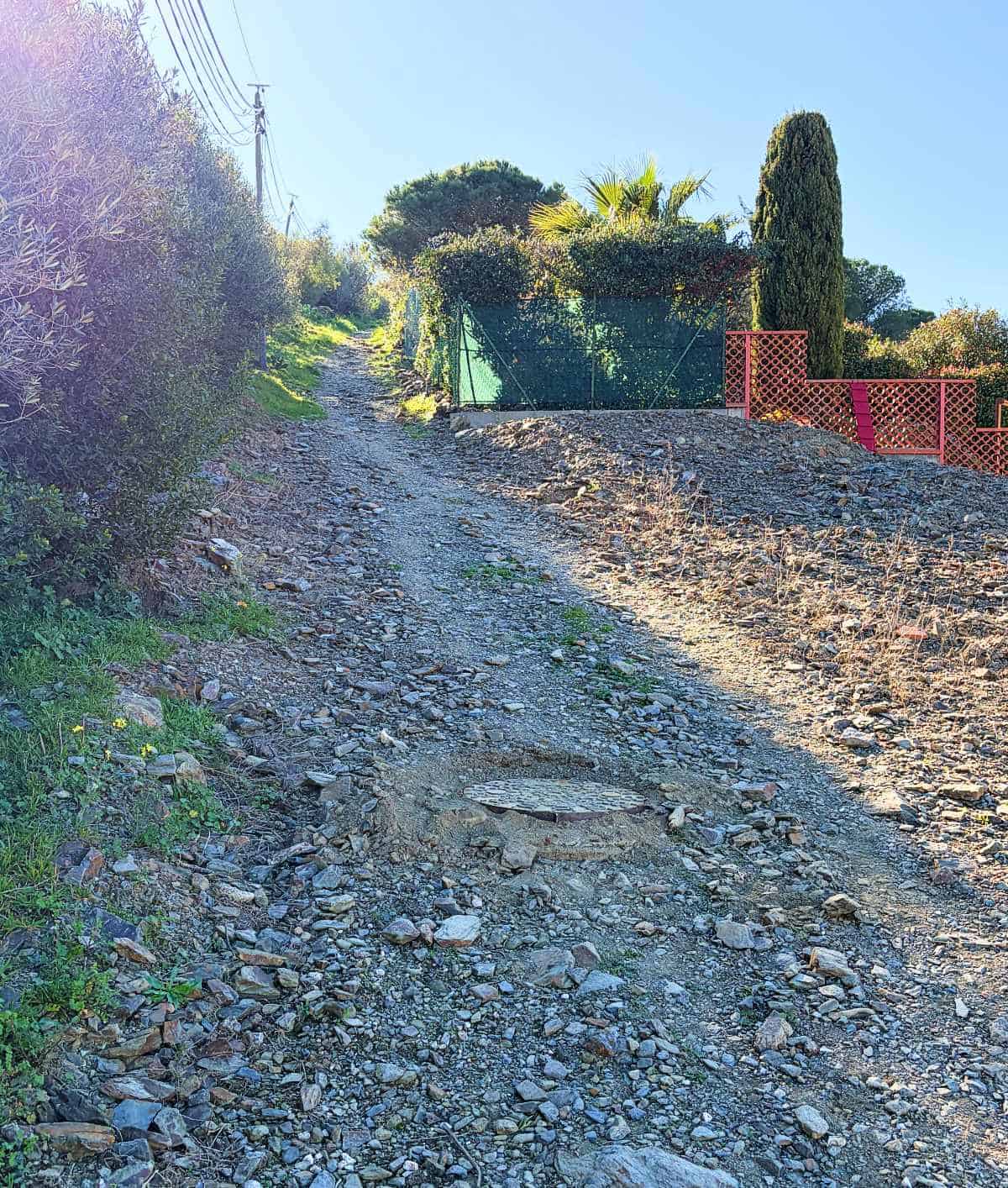 a rocky trail leading up a hill.
