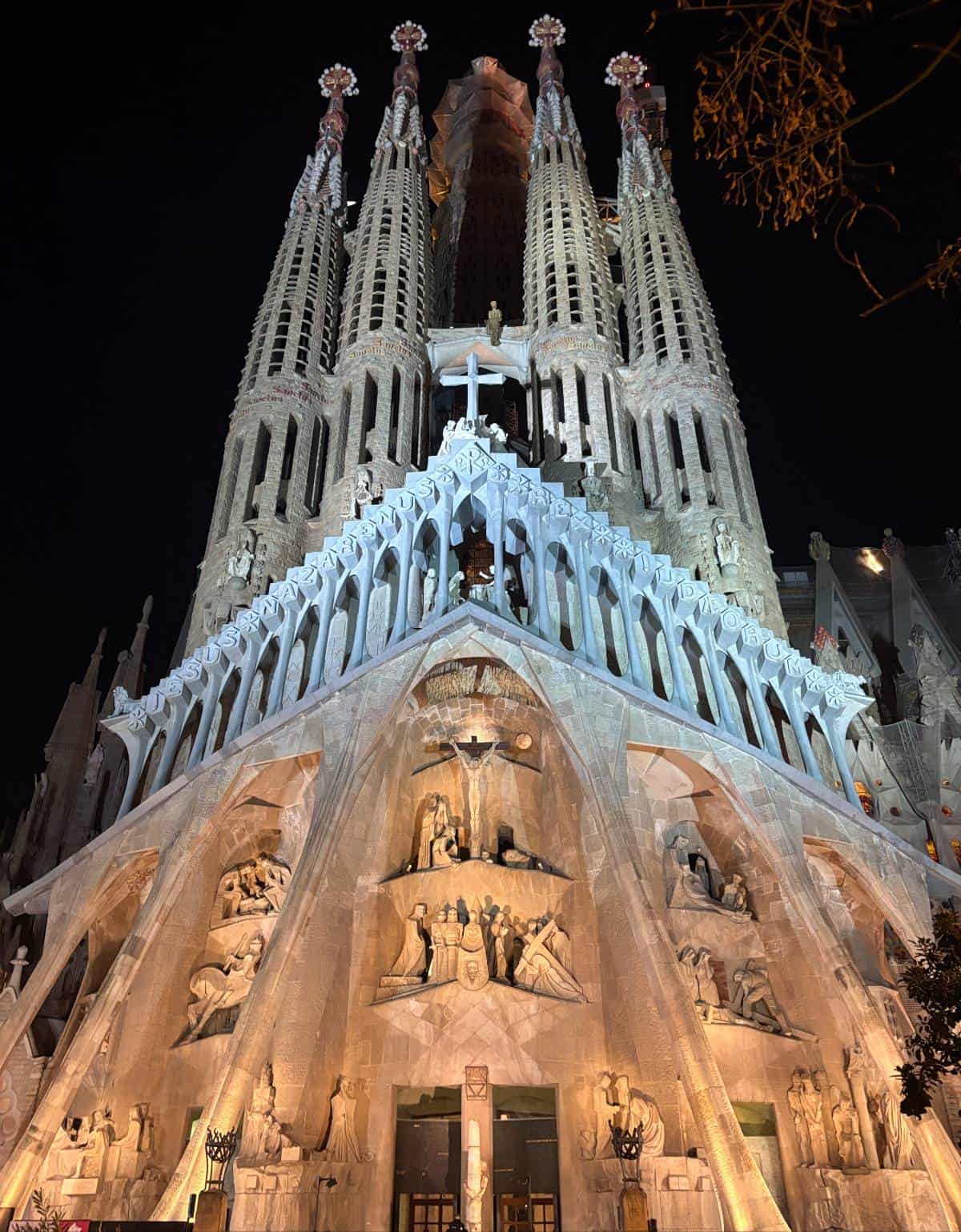 Sagrada Familia lit up at night. Vertical photo showing the entire heigh of the cathedral.