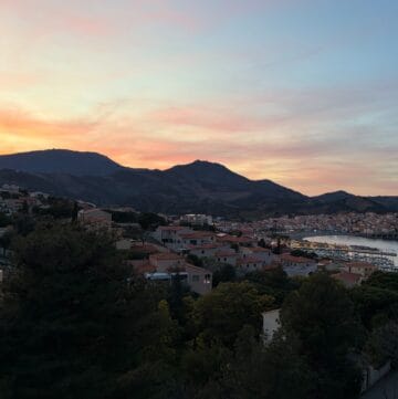 sun setting behind mountains in Banyul-sur-Mer.
