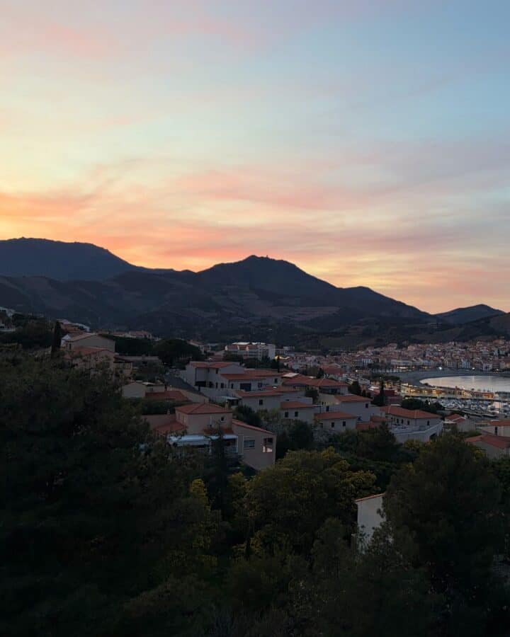 sun setting behind mountains in Banyul-sur-Mer.