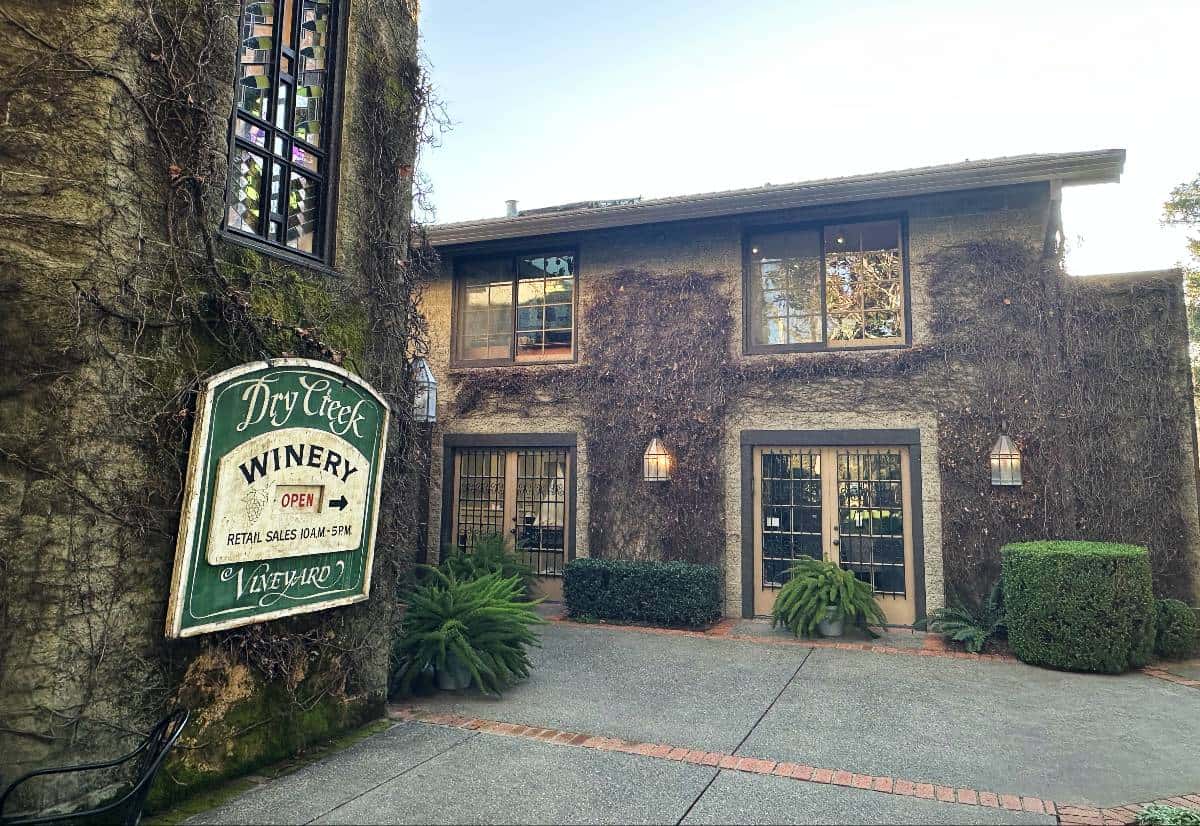 Outside of the Dry Creek Vineyard winery building, with the vineyard sign on the outside.