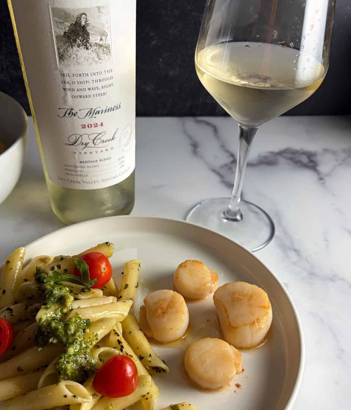 pan seared scallops served with the Mariness white wine and a side of pesto pasta.