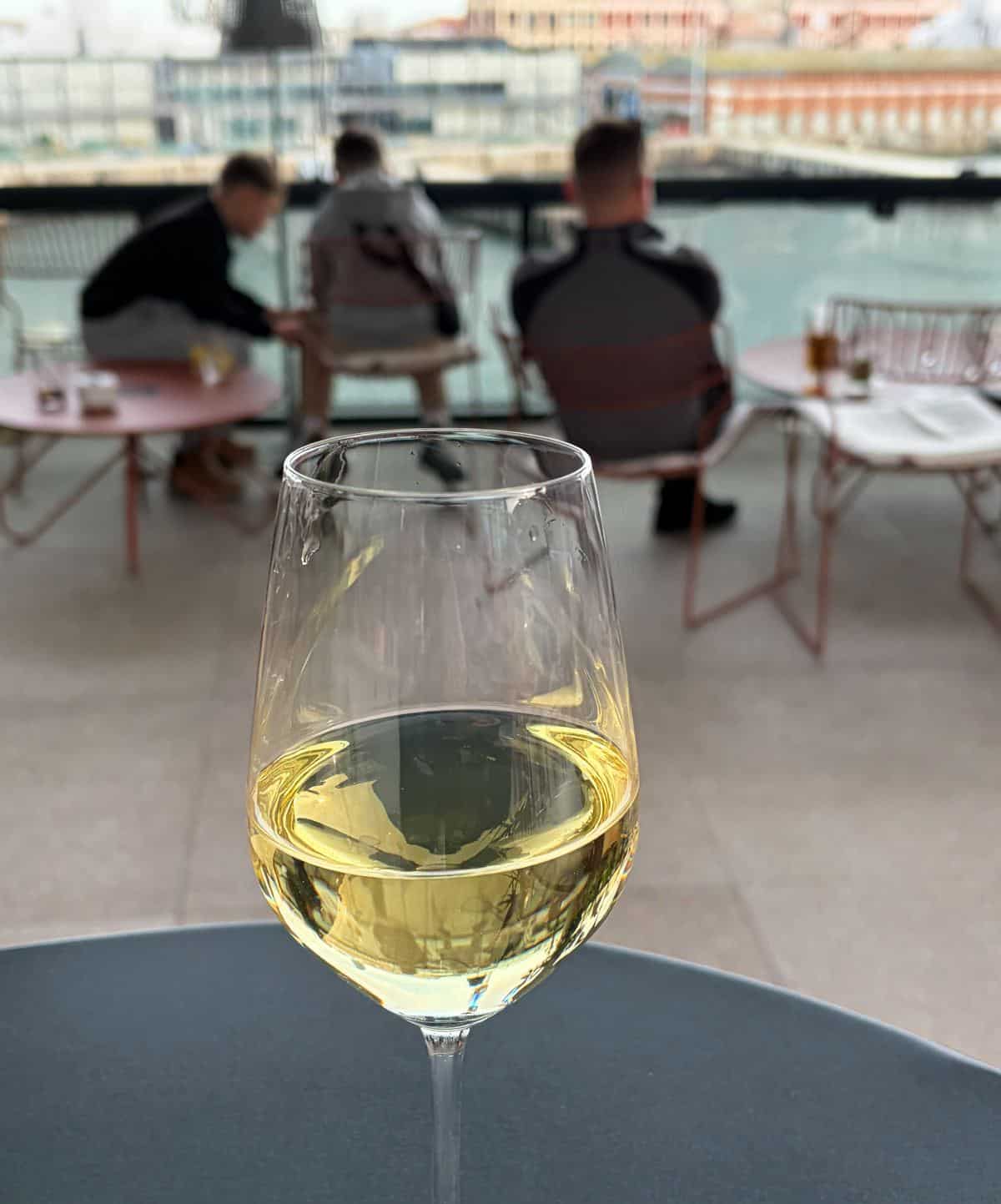 A glass of Albarino at an outdoor bar.