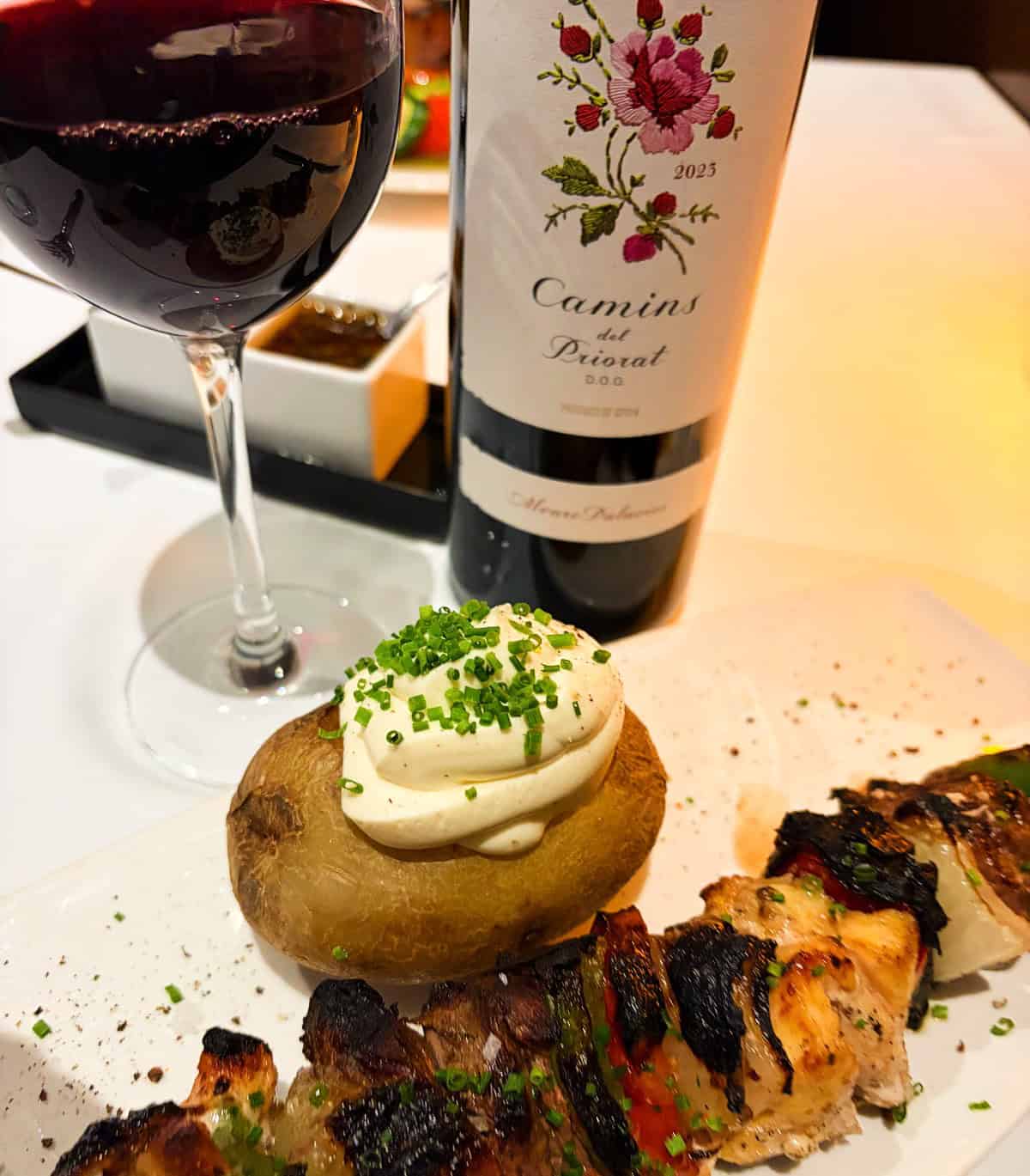 Camins del Priorate red wine served with meat skewers and a baked potato.